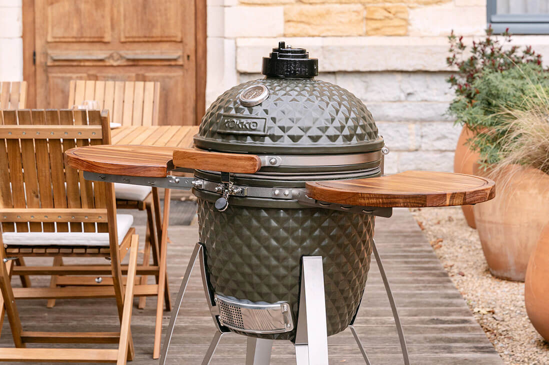 Kamado Kokko 18 pollici in uso, con il coperchio aperto, la regolazione dell’aria e il barbecue utilizzato in una situazione reale.