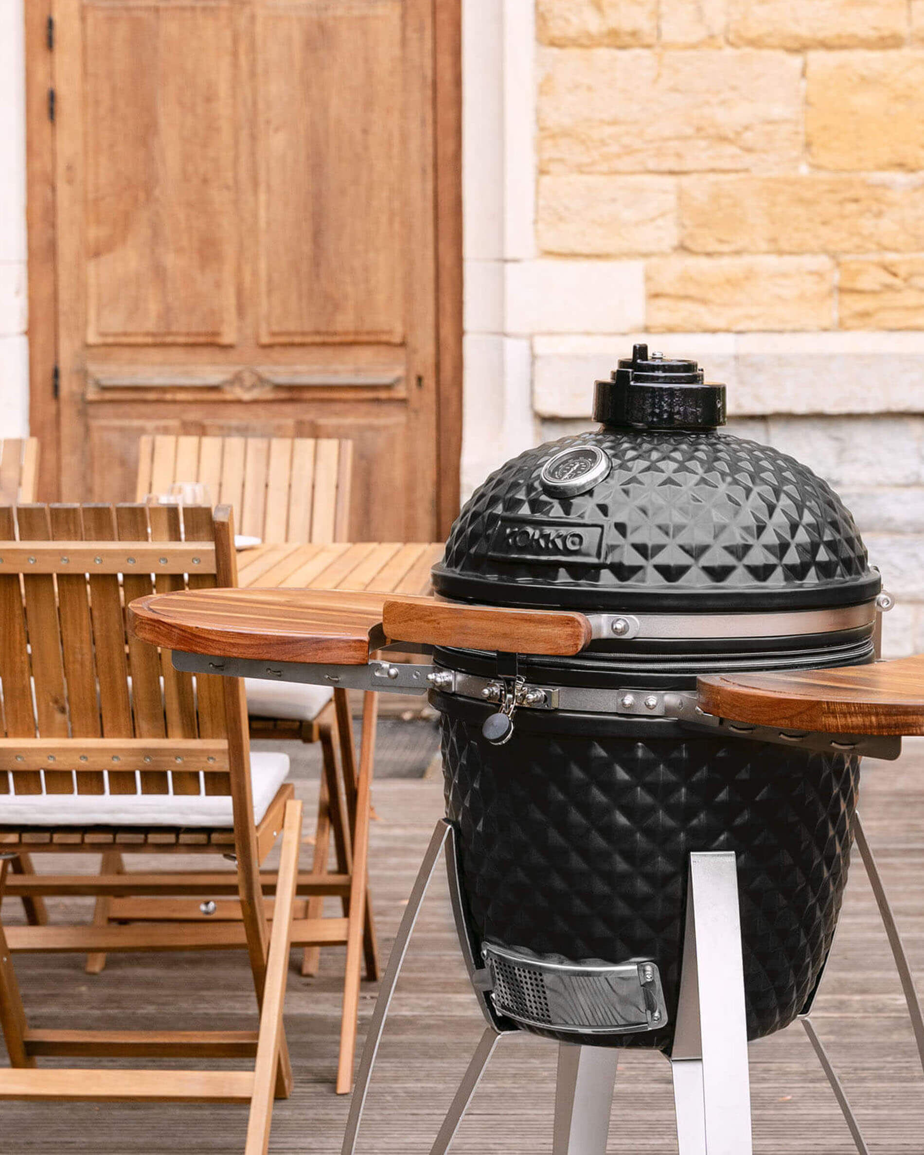 Kamado Kokko 18 pollici nero, presentato da solo all’esterno.